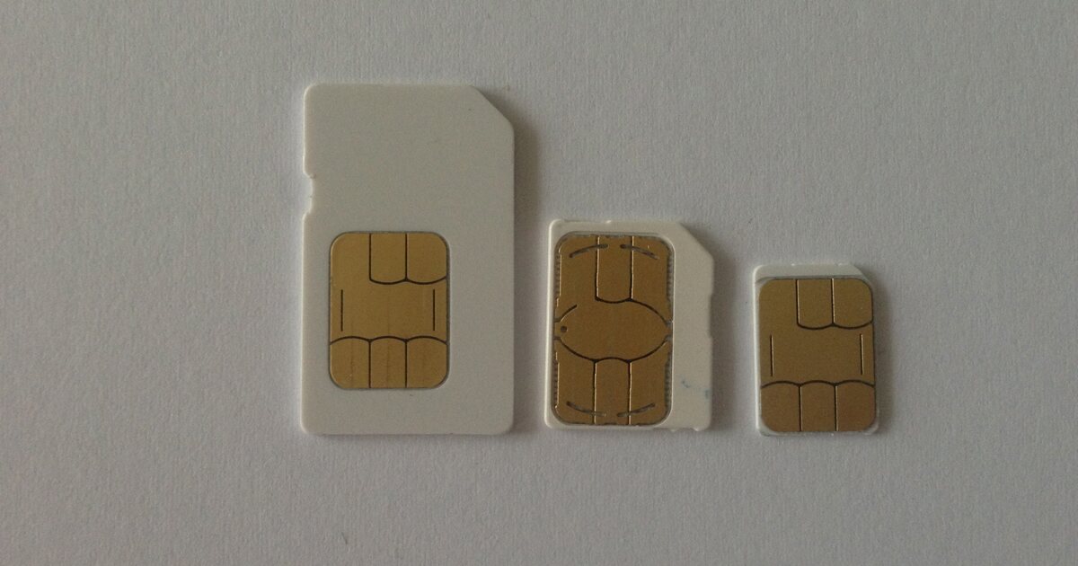 Three SIM cards side by side in descending size - full-size, micro and nano - with their gold contacts facing up