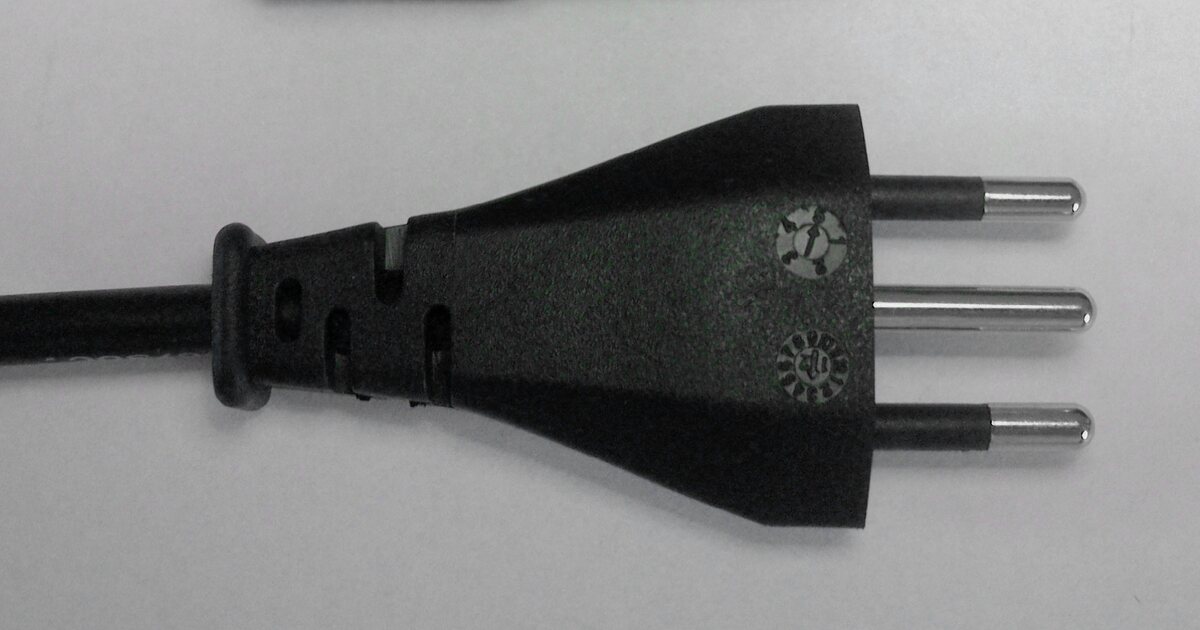 Close-up of a Brazilian three-pin plug to the NBR 14136 standard, its three round pins in a vertical row